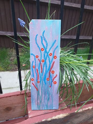 Long broken bathroom tile with orange flowers, blue grass and a coloured background
