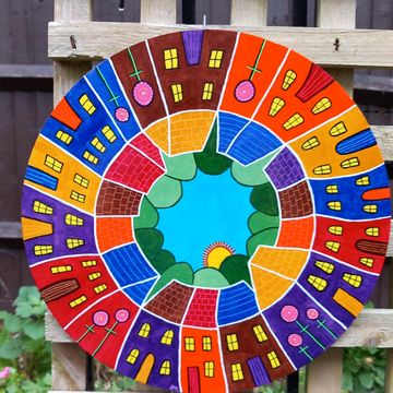 Circle wooden board with colourful abstract houses