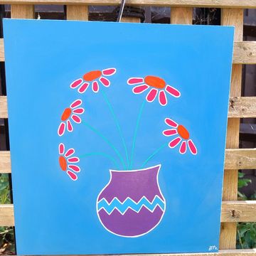 Wooden drawer bottom, blue background with a purple vase filled with orange flowers