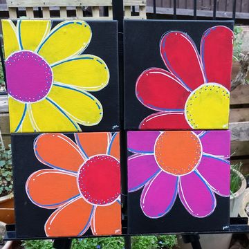 4 square black canvases, with single bright flowers 