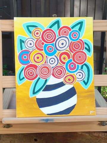 Black & white striped vase with abstract circle flowers with a yellow background