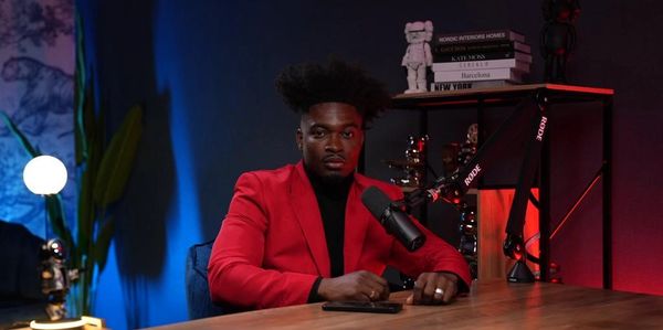 podcaster in dubai podcast studio in red jacket a red lights