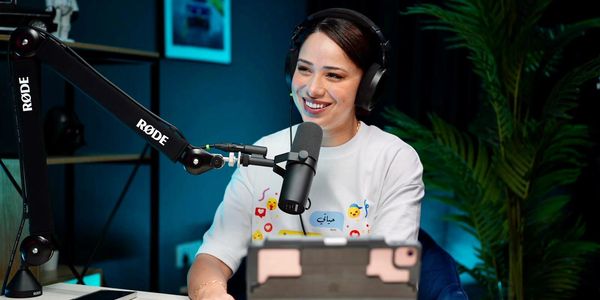 Podcaster recording with a smile at podcast studio dubai 
