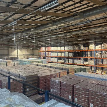 Large warehouse filled with neatly stacked pallets of goods.