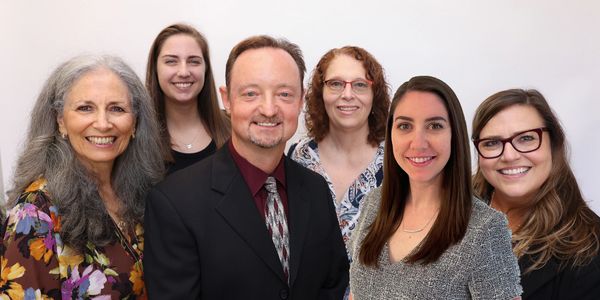 Group of therapists from Wave Therapy smiling at camera