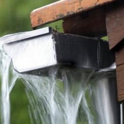 Overflowing gutter with water pouring out.
