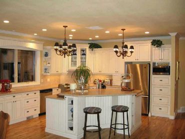 Kitchen remodeling with new cabinets, new hardwood flooring and new tiled backsplash


