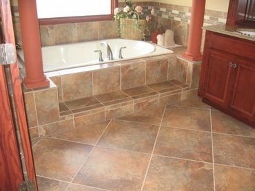 Bathroom Remodeling with new soaker tub and columns, new cabinets, and new tile.