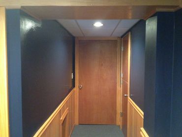 Basement renovations with new paneling, paint and new door.