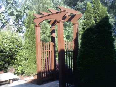 Wooden garden archway with lattice gate.