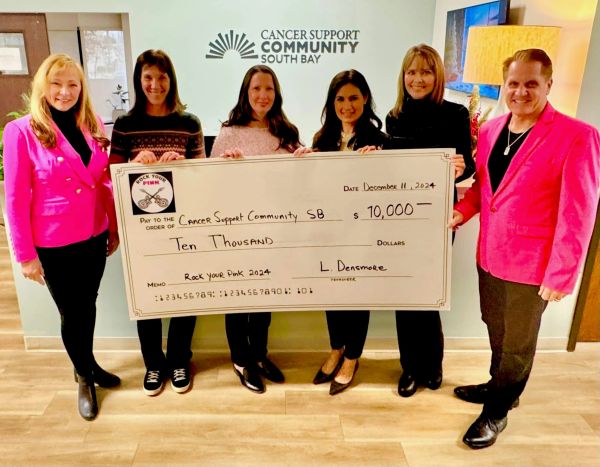 Group holding a large check for $10,000 to Cancer Support Community SB.