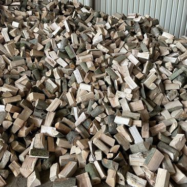 a large pile of firewood logs