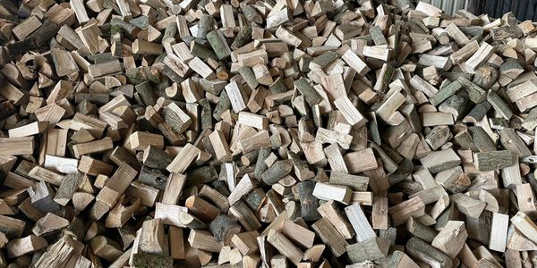 a large pile of firewood logs