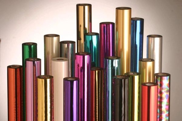 Colorful metallic cylindrical rolls arranged together.