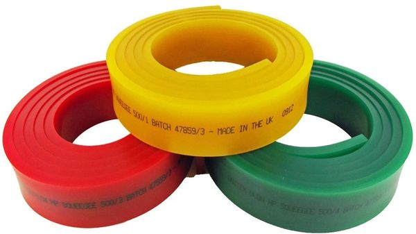 Three coiled rubber bands in red, yellow, and green colors.