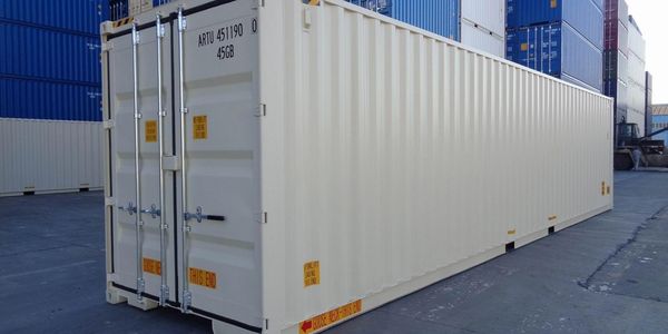 A large white shipping container at a port area.