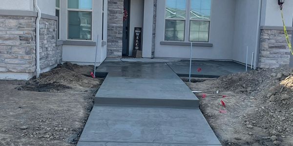 Stamped entrance walkway with step.