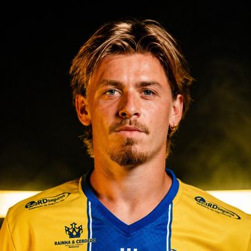 Young man in blue and yellow sports jersey.