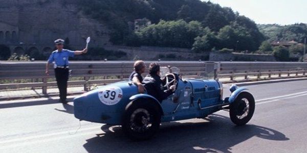 Police marshalling vintage cars on the Mille Miglia, Italy