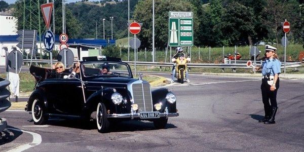 Police marshall cars on the Mille Miglia car rally in Italy