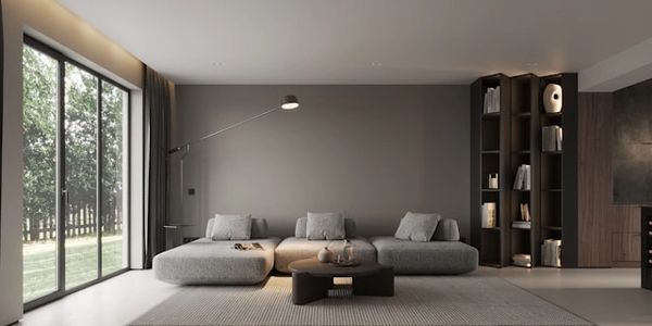 Minimalist living room with gray sofa and large window.