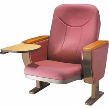 A padded auditorium chair with wooden armrests and an attached writing tablet.