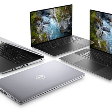 Four Dell laptops, two open displaying nature wallpaper, two closed or angled.
