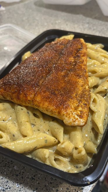 Blackened Salmon over creamy and cheesy pasta Alfredo. 
