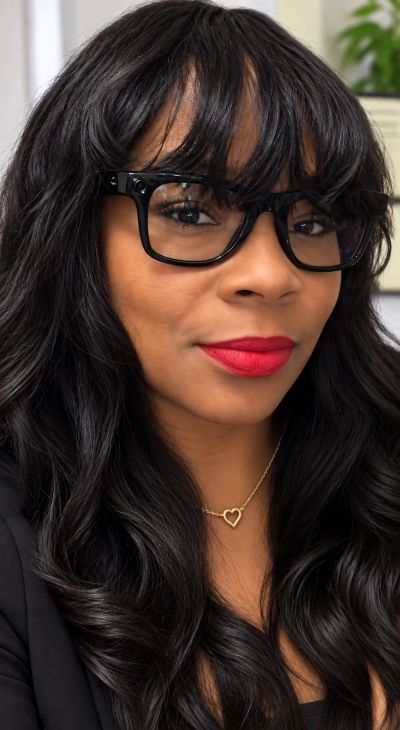 Woman with black glasses and red lipstick.