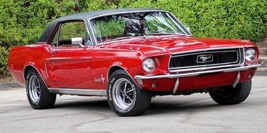 Classic red Ford Mustang with black roof.