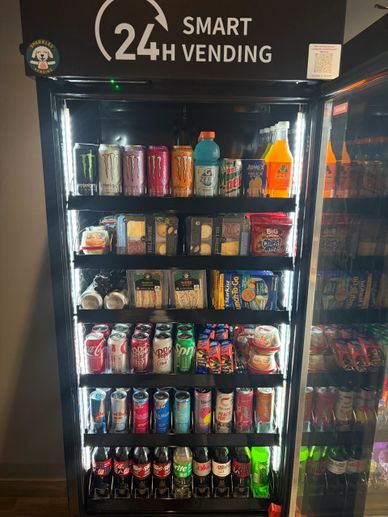 A smart vending machine filled with drinks and snacks, available 24 hours.