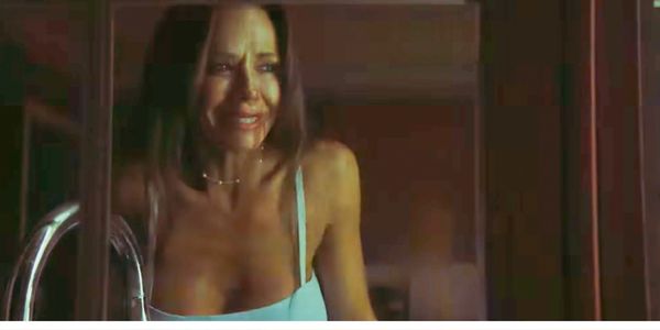 Woman looking emotional, possibly crying.