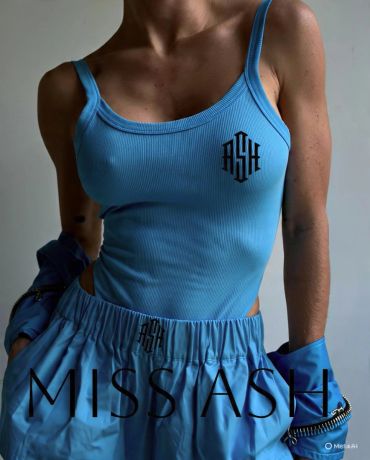 Woman in blue outfit with Miss Ash logo.
