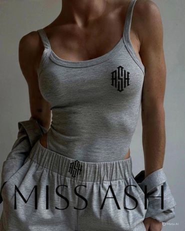 Woman in grey athletic wear with logo.