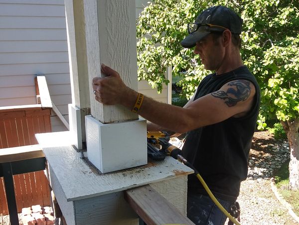 Ernest replacing wood rotten trim with new rot resistant trim on a porch column in Highlands Ranch C
