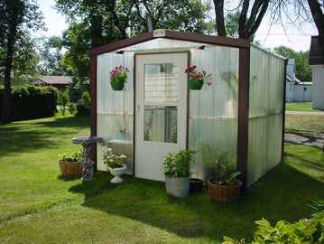 Greenhouse with Lexan and steel trim. Comes standard with walk door.  Various colors available.