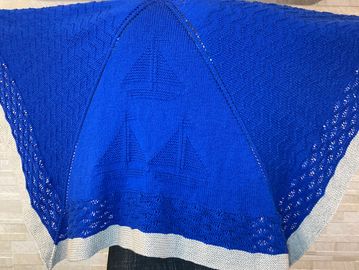 Wedge shaped shawl featuring boats and waves