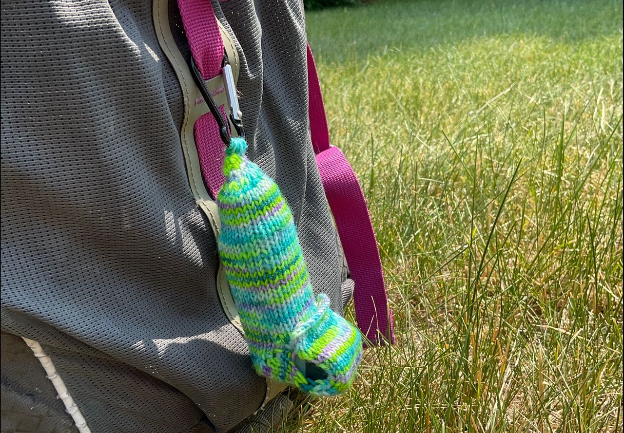An emergency Asthma Inhaler Carrier attached to the outside of a backpack. 