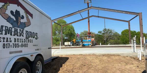 Construction site with metal frame and trailer.
