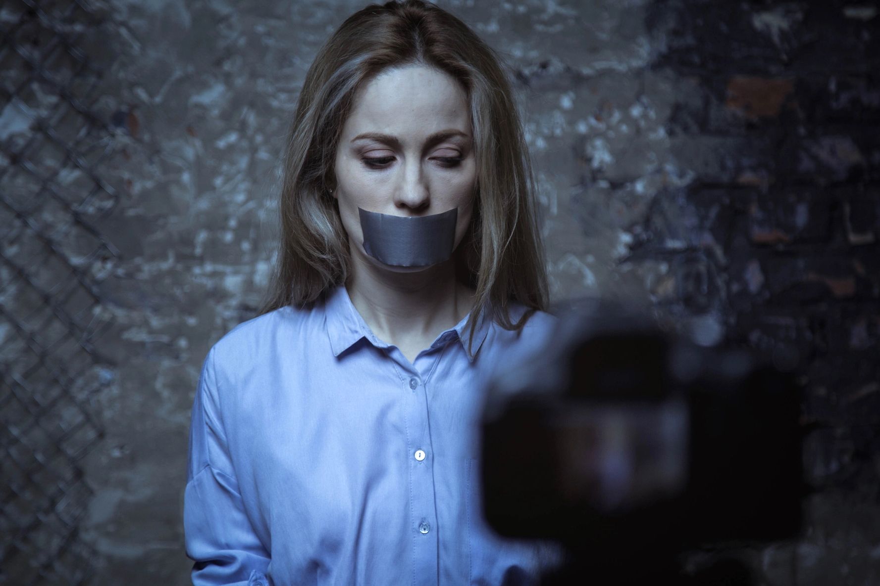 A woman kidnapped with mouth closed with a black tape