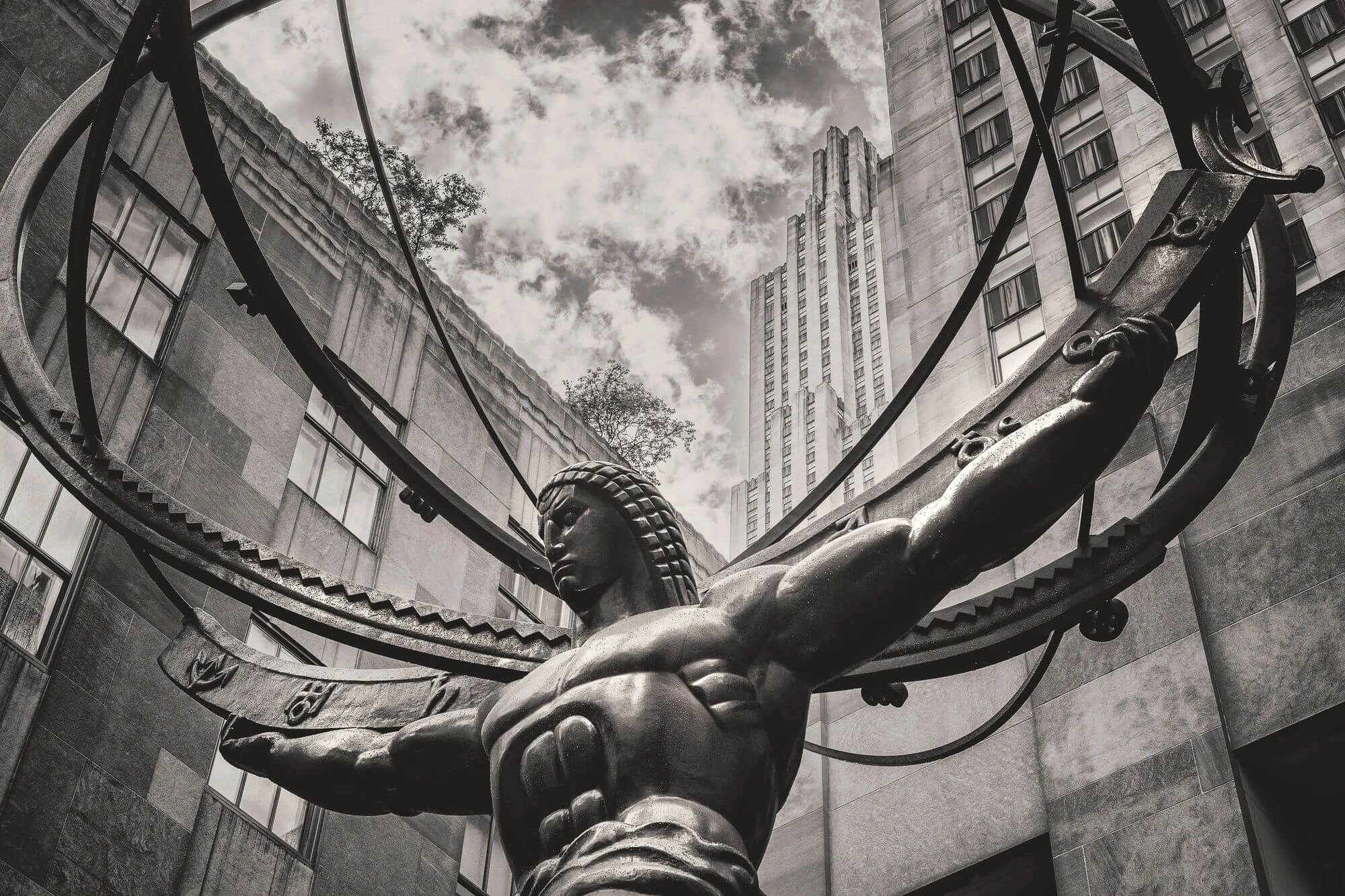 Historic statue of a man holding a wheel