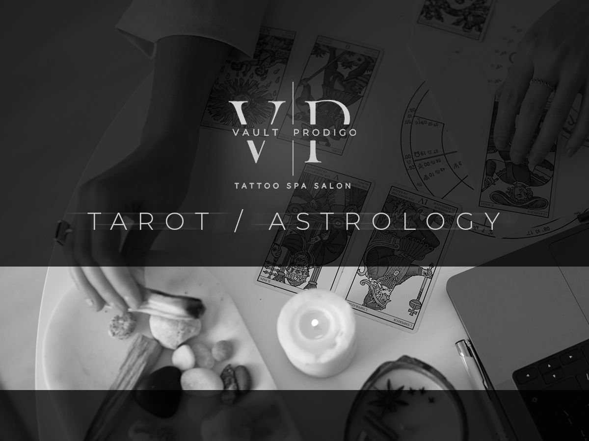Hands performing tarot card reading with candle and stones.