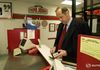 Senator Bill Bradley tries to find cash in his wallet to buy late night takeout pizza after Al Gore defeated him in the 2000 New Hampshire primary