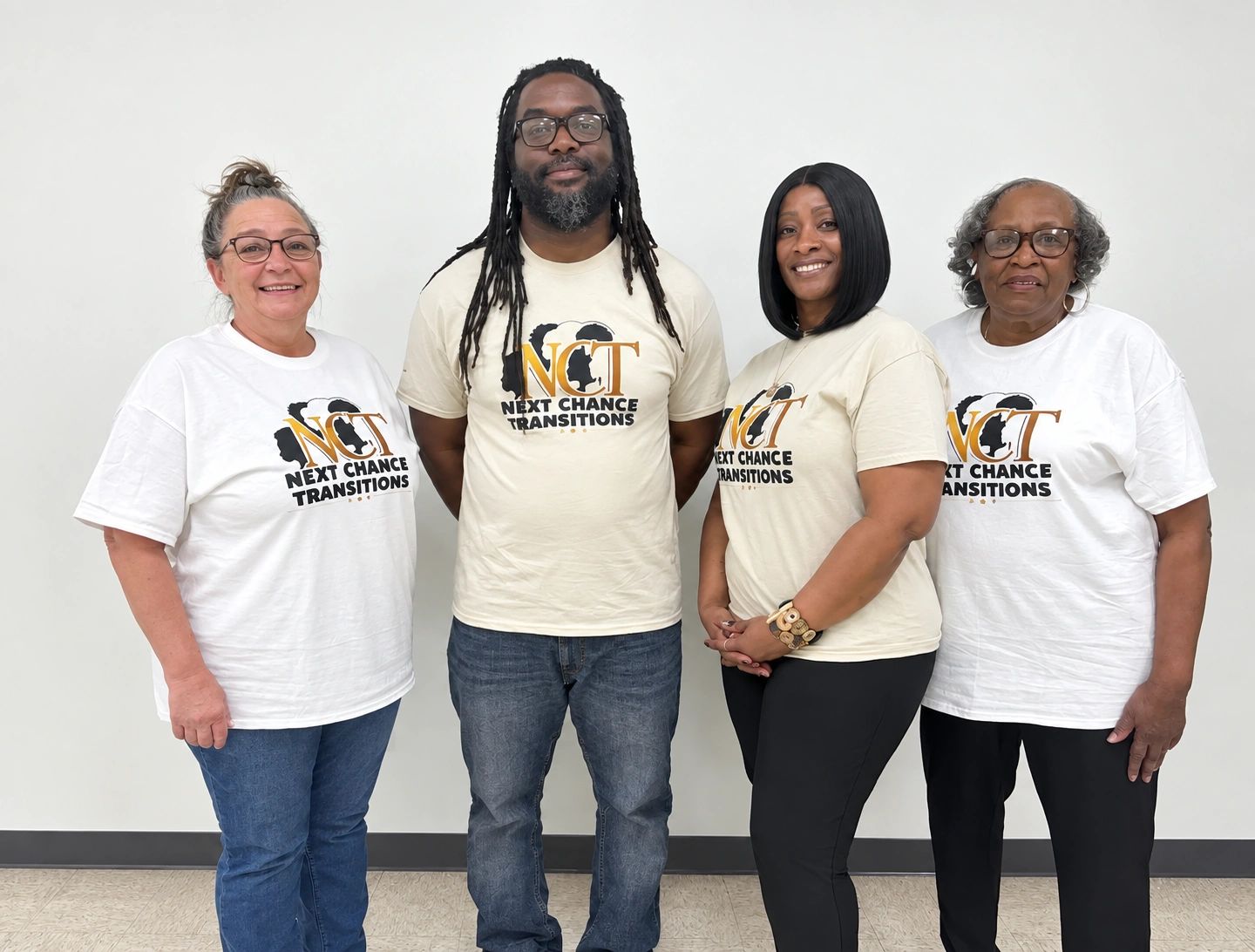 Group of four people wearing Next Chance Transitions shirts.