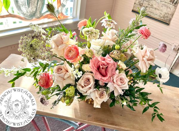 Elegant floral bouquet with roses and greenery.