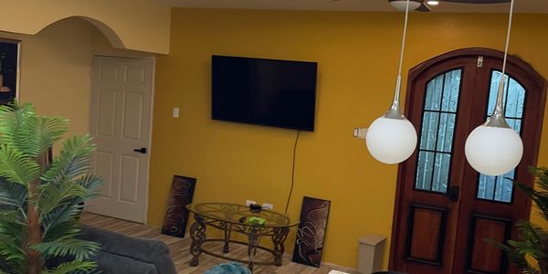 Cozy living room with yellow walls and modern decor.