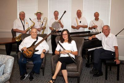 Picture of the eight members of the Riverboat Jazz band and their instruments.
