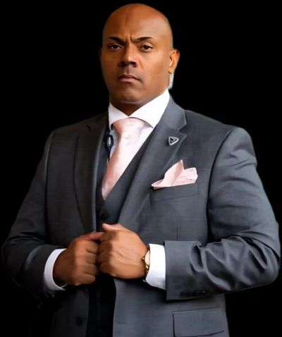 Confident man in a gray suit adjusting his jacket.