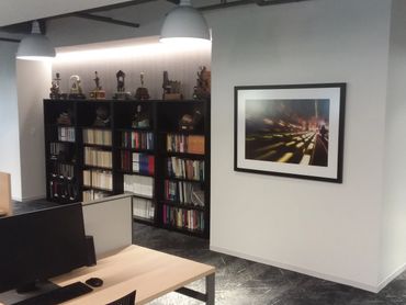 Framed poster hung at eye level in office suite