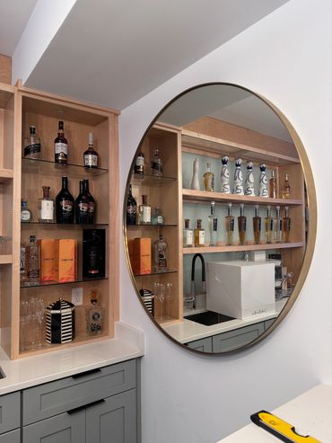 Arlington,VA mirror hanging in bar area. installation done with french cleat